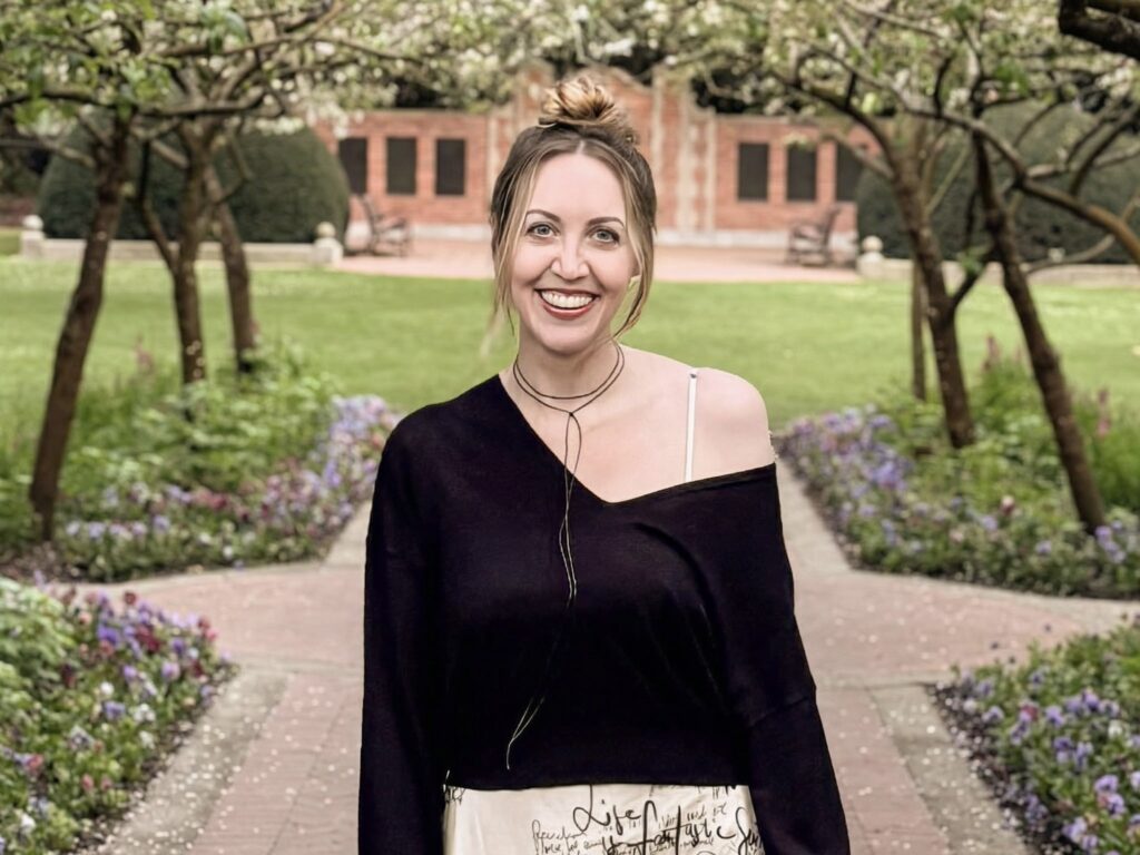Ann Pierce standing on a garden path